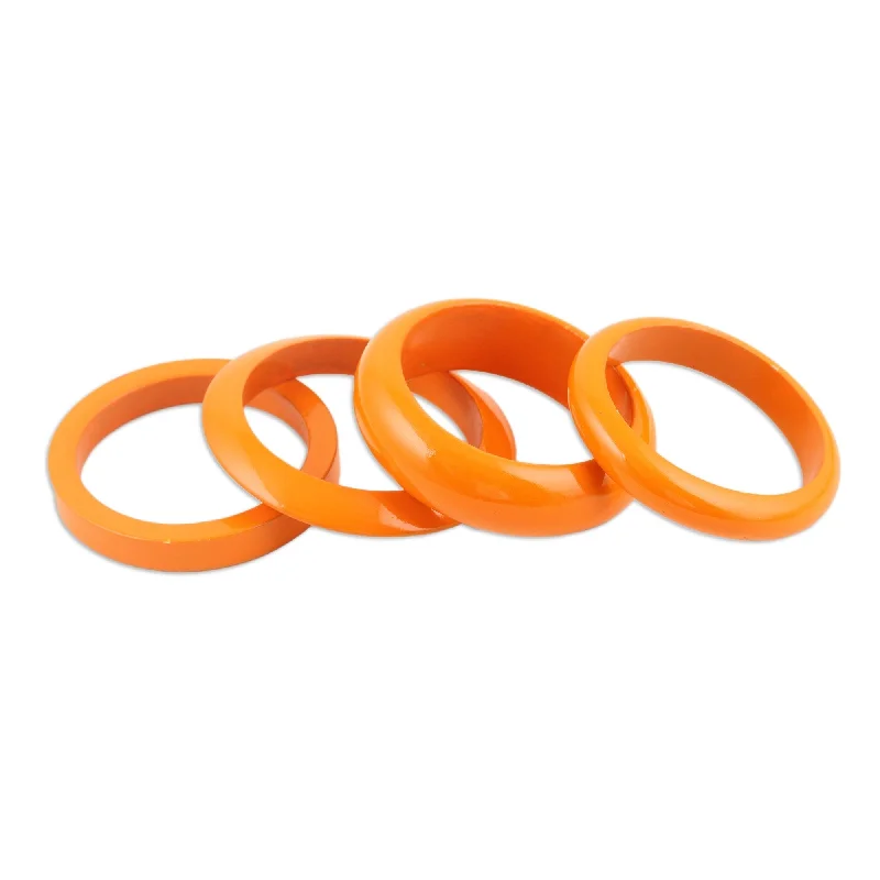 Women’s stretch bracelets-Novica Handmade Orange Fusion Mango Wood Bangle Bracelets (Set Of 4)