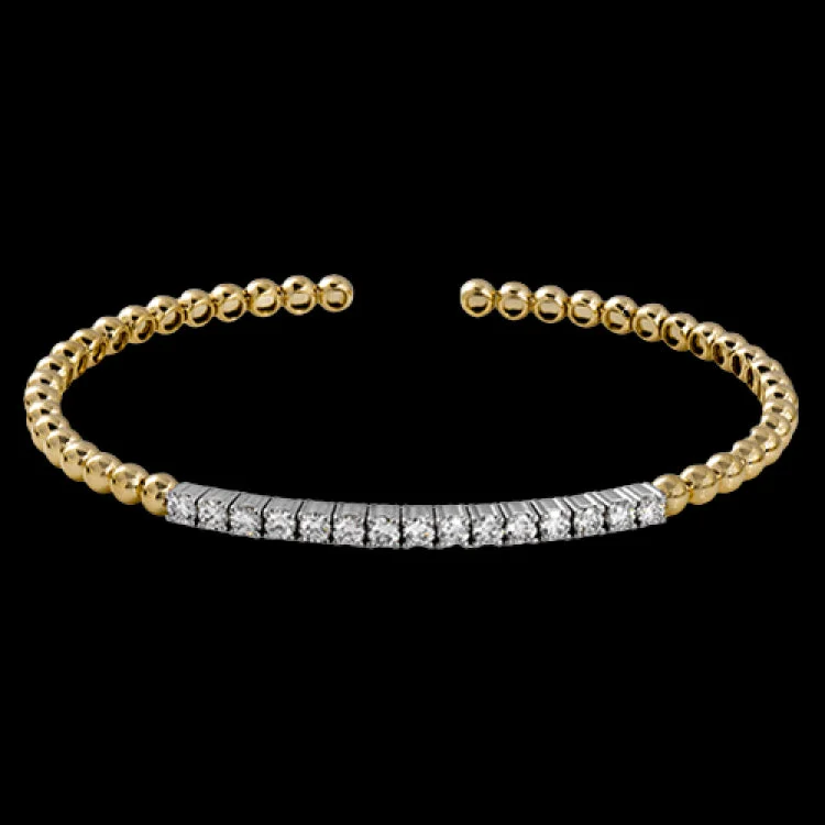 Women’s boho bangles-This wonderful bangle showcases a straight line of .97 ctw of white diamonds set within 18k yellow gold beads.