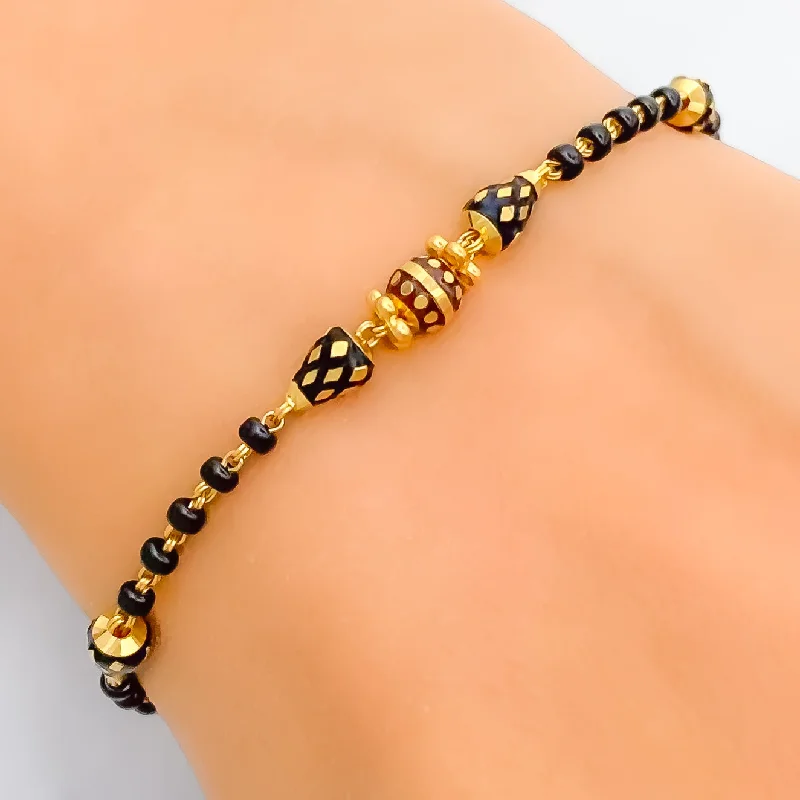 Women’s gemstone studded bracelets-Luminous Lightweight 22k Gold Black Bead Bracelet