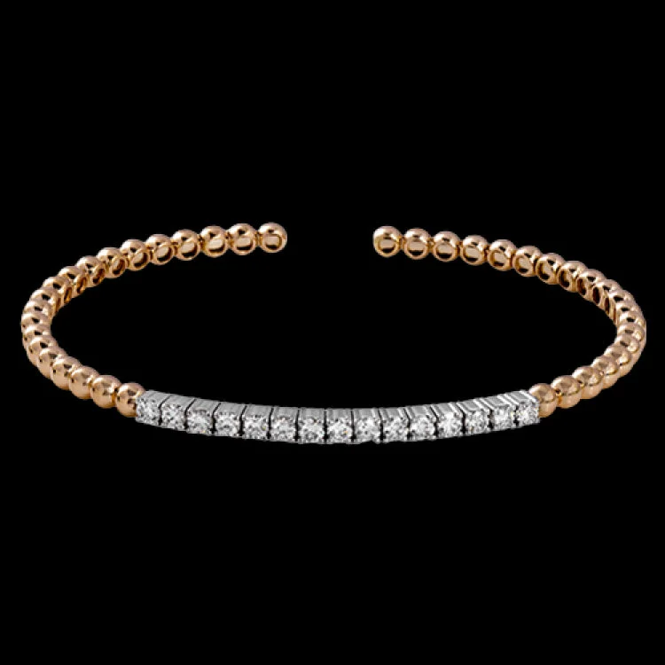 Women’s custom bracelets-This wonderful bangle showcases a straight line of .97 ctw of white diamonds set within 18k rose gold beads.