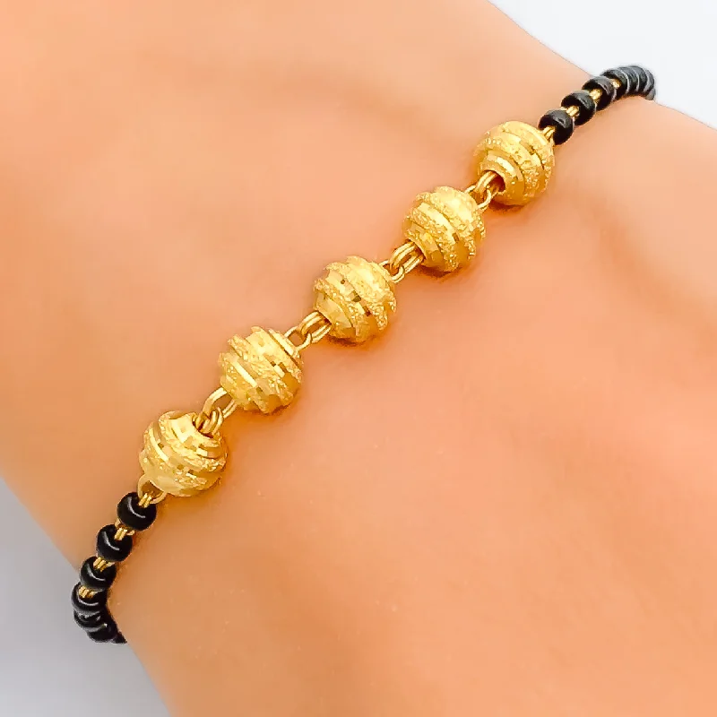 Women’s braided bracelets-Radiant Ornate 22k Gold Black Bead Bracelet