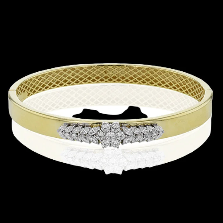 Women’s modern bangles-A gleaming yellow gold bangle in 18K, adorned with a cluster of diamonds in a floral pattern combines RD stones 0.52 ctw., and Mq diamonds 0.81ctw.